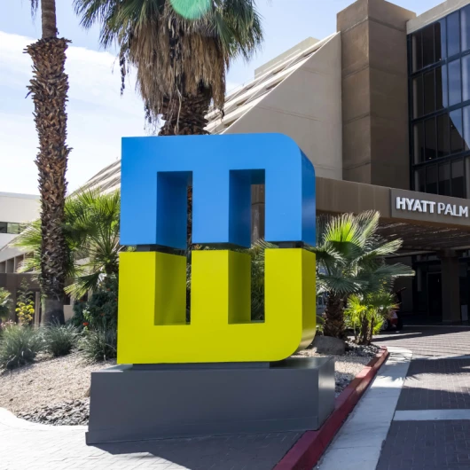 Modernism Week logo statue positioned in front of the Hyatt Palm Springs and Modernism Week CAMP