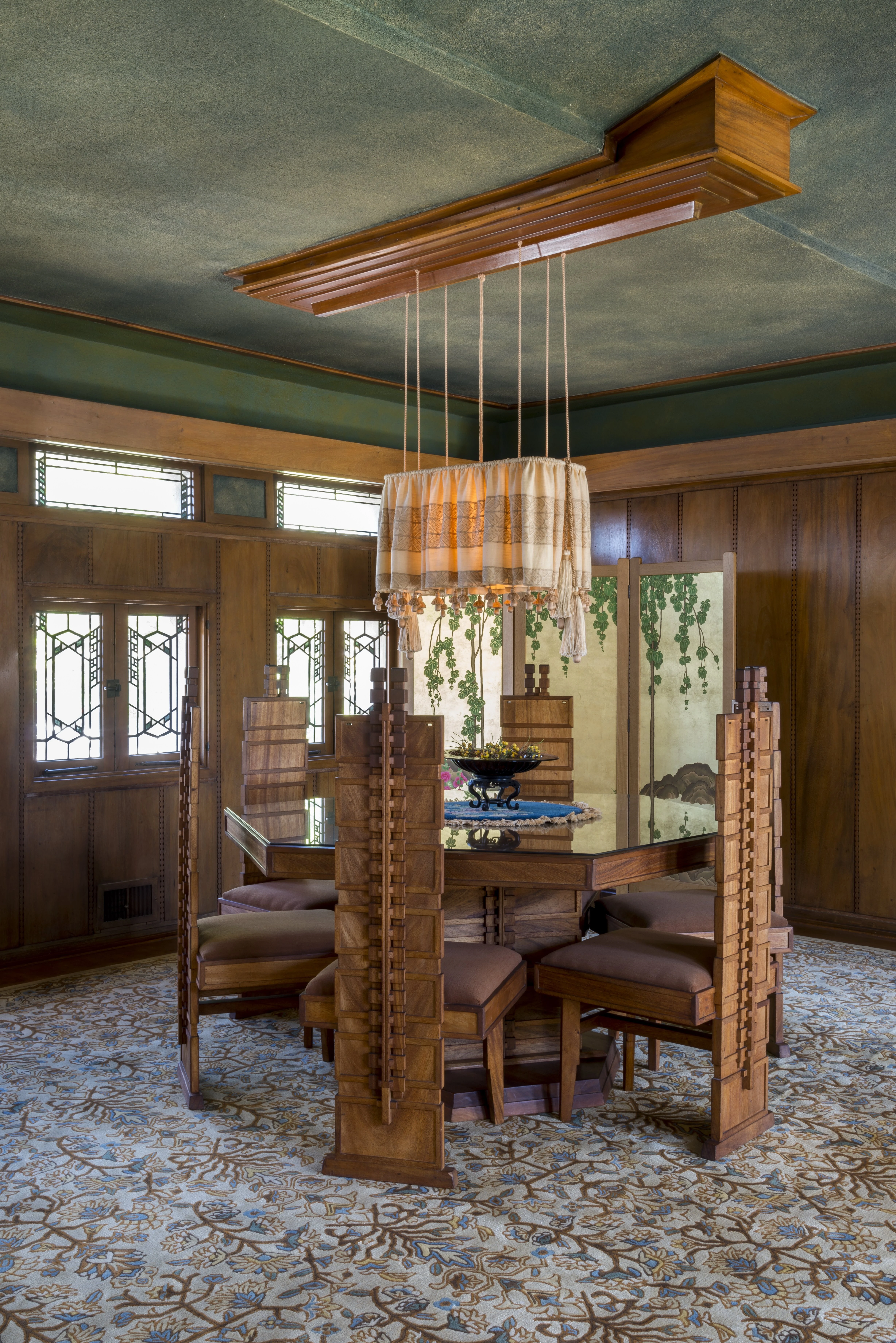 Dining room in Frank Lloyd Wright's Hollyhock House featuring architecturally matching table and chairs