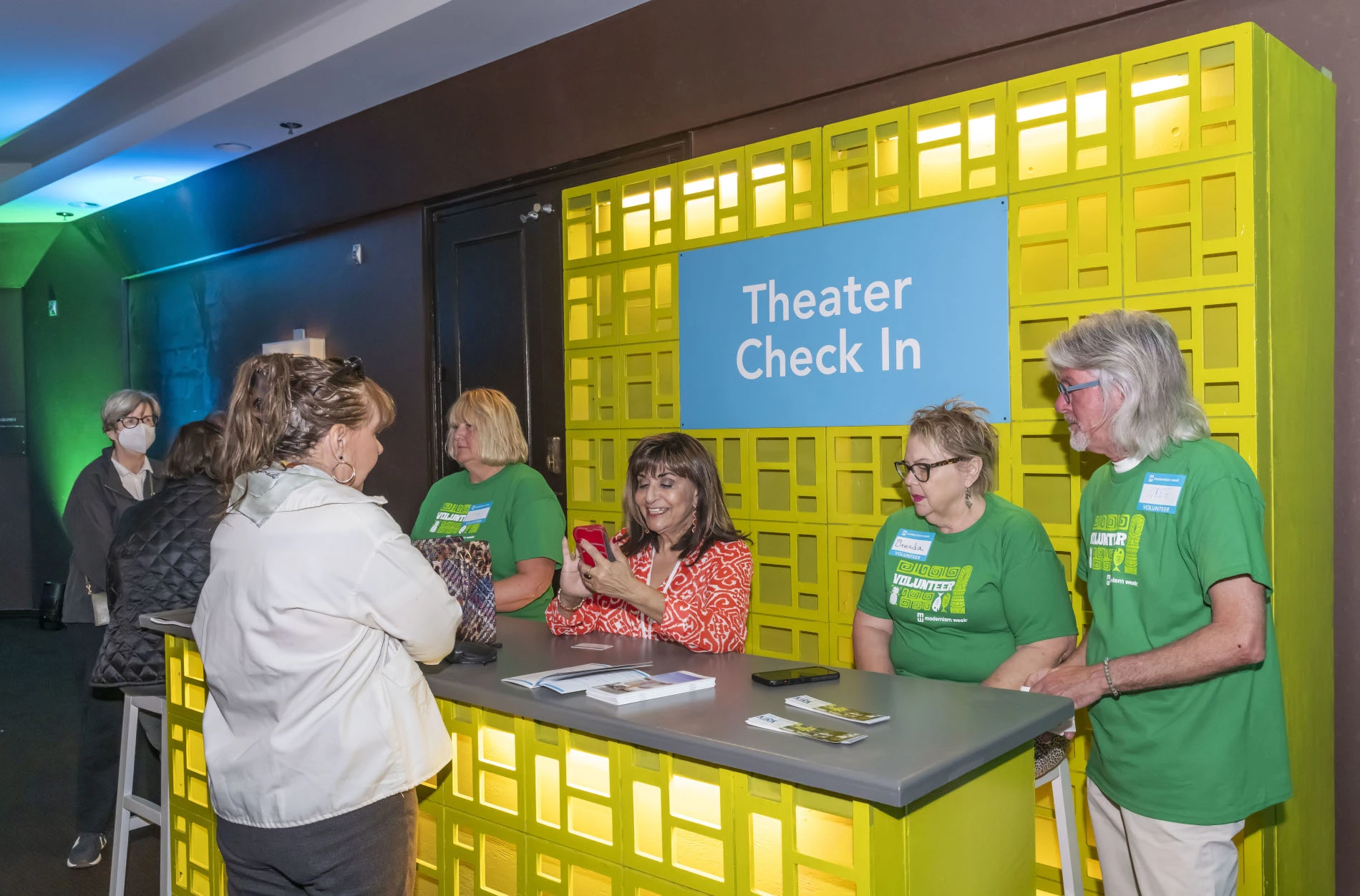 Volunteers at a theater check-in desk at Modernism Week