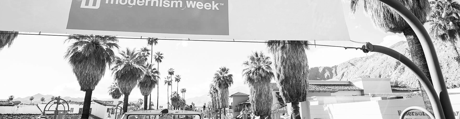 South Palm Canyond Drive en Palm Springs, CA con palmeras y Modernism Week banner