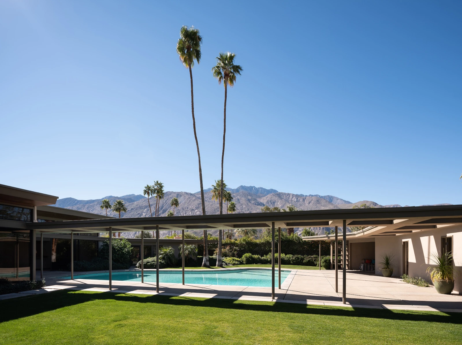 Wide view of Frank Sinatra's 'Twin Palms' estate with a pool and two palm trees